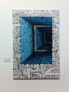 an art piece with blue and white designs on it