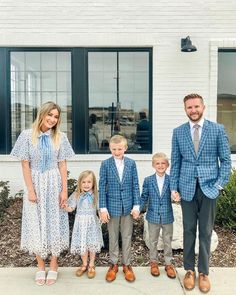 a family poses for a photo in front of a building