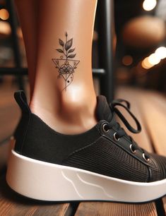 a woman's foot with a tattoo on it