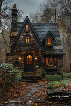 a stone house in the woods at night