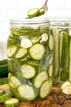 pickled cucumbers in mason jar with spoon