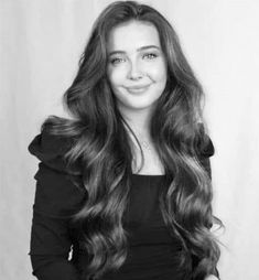 a black and white photo of a woman with long hair