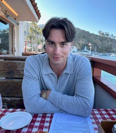 a man sitting at a table with food on it