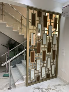 an open door leading to a staircase with mirrors on the wall and glass railings