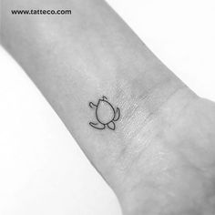 a small tattoo on the wrist of a person's arm with a cat design