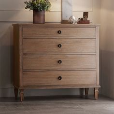 a wooden dresser with flowers on top of it