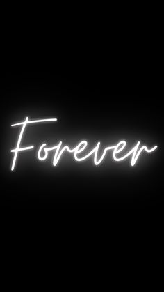 the words forever are lit up against a black background