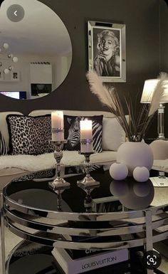 a living room filled with lots of furniture and candles on top of a coffee table