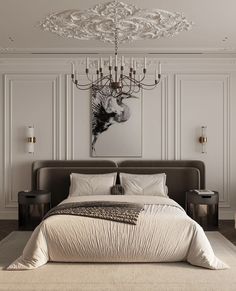 a large bed sitting under a chandelier next to a painting on the wall