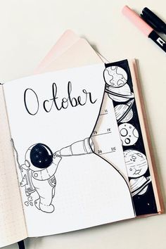 an open notebook with the word october written on it