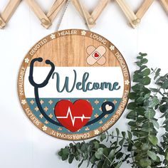 a wooden sign that says welcome with a stethoscope and heart on it