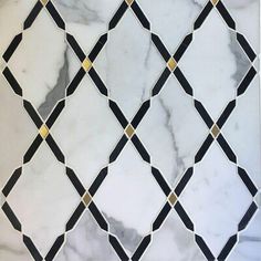 a white marble tile with black and gold lines