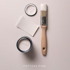 a paintbrush and some other items on a white surface with the words potter's pink