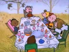 a family sitting at a table for a thanksgiving dinner in the woods with charlie brown