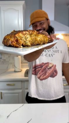 a man holding a tray with some food on it