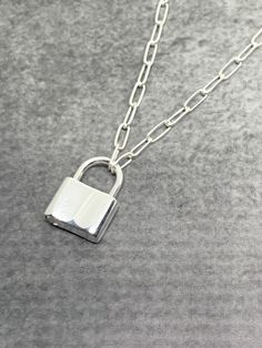 Solid Sterling Silver Padlock and Paperclip Cable Chain Necklace - Both the chain and padlock are sterling silver. - This chain and the padlock are very sturdy and not hollow. - Each link is approximately 5.7mm long. - The padlock is approximately 15mm x 12mm. - The padlock opens by pulling up on the U shape at the top of the padlock. This is how you put the necklace on. There is no clasp. - This necklace is also available in a larger chain and padlock version in my shop. Sailor Jerry Anchor, Necklace Lock, Ribbon Choker Necklace, Nautical Necklace, Ribbon Choker, Padlock Necklace, Paperclip Chain Necklace, Paperclip Necklace, Elongated Oval