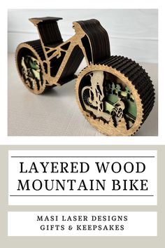 a wooden mountain bike is shown with the text layered wood mountain bike masi laser designs gifts