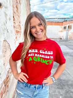 Add a unique twist to your holiday wardrobe with this Mrs. Claus But Married to a Grinch Graphic T-Shirt. Featuring bold colors and a fun festive graphic, this shirt will make you stand out in a crowd. Its comfortable fabric will keep you feeling cozy and stylish throughout the holiday season. Get ready to make a statement! Grinch Graphic, Mrs Claus, Holiday Wardrobe, Grinch, Bold Colors, The Holiday, Holiday Season, Graphic T Shirt, Graphic Tshirt