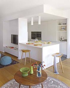 a living room filled with furniture and a flat screen tv on top of a wooden table