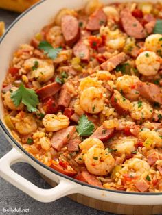 seafood paella with shrimp, mussels, and sausage in a skillet