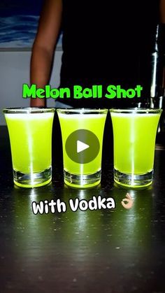 three shot glasses sitting on top of a counter with the words neon ball shot in front of them