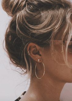 a woman with large hoop earrings on her ear