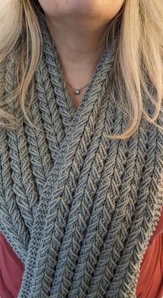 a woman wearing a gray knitted scarf