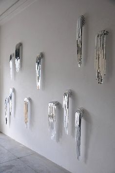 the wall is covered in many different metal objects