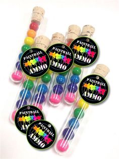 some colorful lollipops are in a clear tube with the words paint party on them