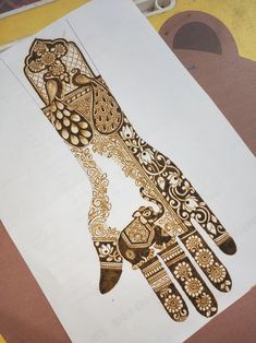 an intricately designed hand is shown on paper