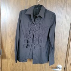 Elie Tahari Black Ruffled Tuxedo Shirt Size Medium Like New Condition Thanks For Stopping By! Feel Free To Leave Me A Comment So That I Can Check Out Your Closet Too. :) Please Know That All Sales Are Photographed And Recorded Before Being Packaged And After Packaging To Ensure Your Protection And Mine. All Items Without Nwt Are In Gently Used Condition. Please Always View Photos For Details. Always Ask Questions Before Buying. Purchases Can Not Be Returned Always Read The Listing. Examine All P Black Ruffled Shirt For Formal Occasions, Black Formal Shirt With Ruffles, Formal Black Shirt With Ruffles, Tuxedo Shirt, Tuxedo Shirts, Elie Tahari, Black Ruffle, View Photos, Button Down Shirt