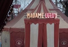 a circus tent with the words madam louis written on it