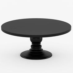 a black round table sitting on top of a white floor