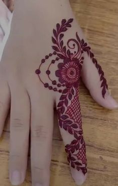 a woman's hand with henna on it