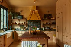 a kitchen with wooden cabinets and an island in front of a window that has flowers on it