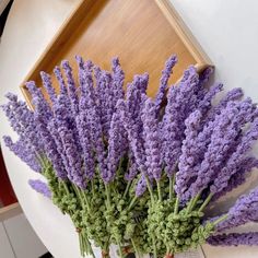 three vases filled with purple flowers on top of a table