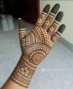 a woman's hand is decorated with henna