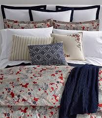 a bed with red, white and blue comforters on it's headboard