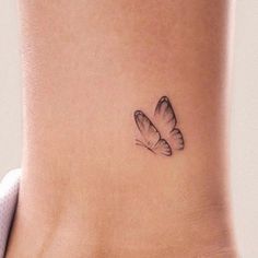 a small butterfly tattoo on the ankle