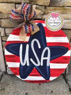 a red, white and blue wooden sign with the word usa on it