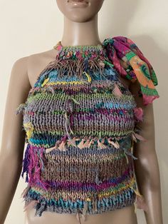 a mannequin wearing a multicolored knitted top