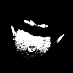 a black and white image of a man's face with his mouth open in the dark