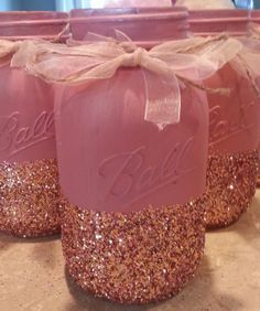 three jars with pink and gold glitter on them