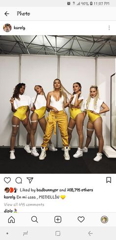 a group of women in yellow outfits posing for a photo