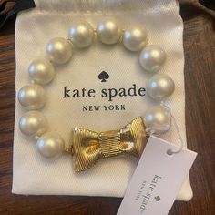 Pearl Bracelet Approx 8.5 Inches Long Cream/Gold Never Worn Comes With Bag Tongue And Box Closure Elegant Gold Bracelets For Holiday, Elegant Gold Bracelets For Holidays, Elegant White Kate Spade Bracelet, Elegant White Bracelets For Holiday, Travel Charm Bracelet, Kate Spade Heart, Kate Spade Bracelet, Kate Spade Bangle, Pearls Bracelet