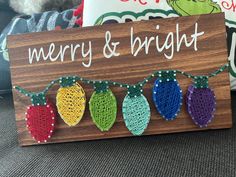 a wooden sign with christmas lights on it