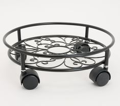 a black metal tray with wheels on it