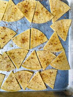 tortilla chips on a baking sheet ready to go into the oven