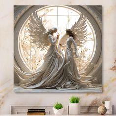 two white angels standing next to each other in front of a round window with the sun shining through