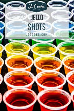 colorful jello shots in plastic cups with the words jello shots on top and bottom